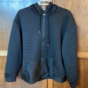 Black waffle hoodie with kangaroo pocket.